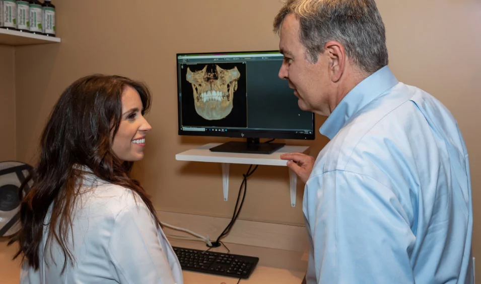 Dr. Girmscheid reviewing x-rays with a patient